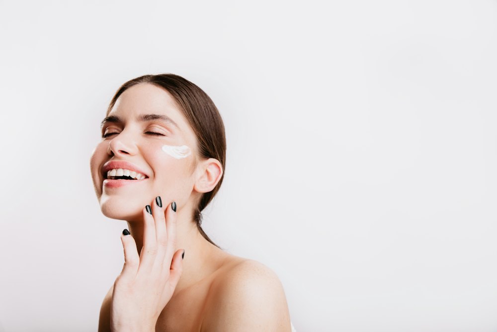 Woman laughing with a dab of cream on her cheek
