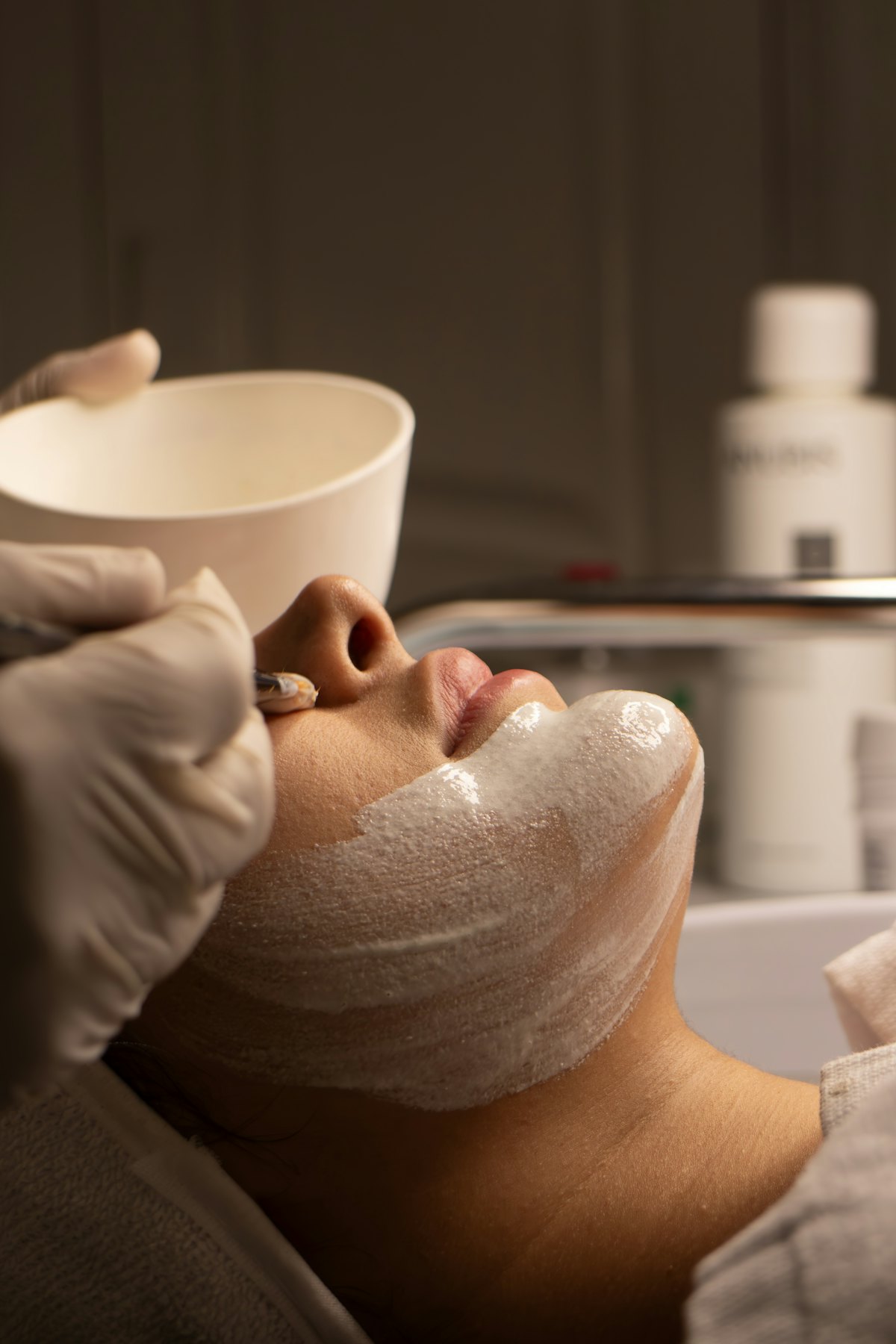 Client resting during a facial mask treatment